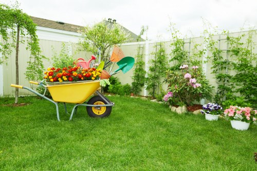 Garden maintenance worker following weather-aware safety procedures